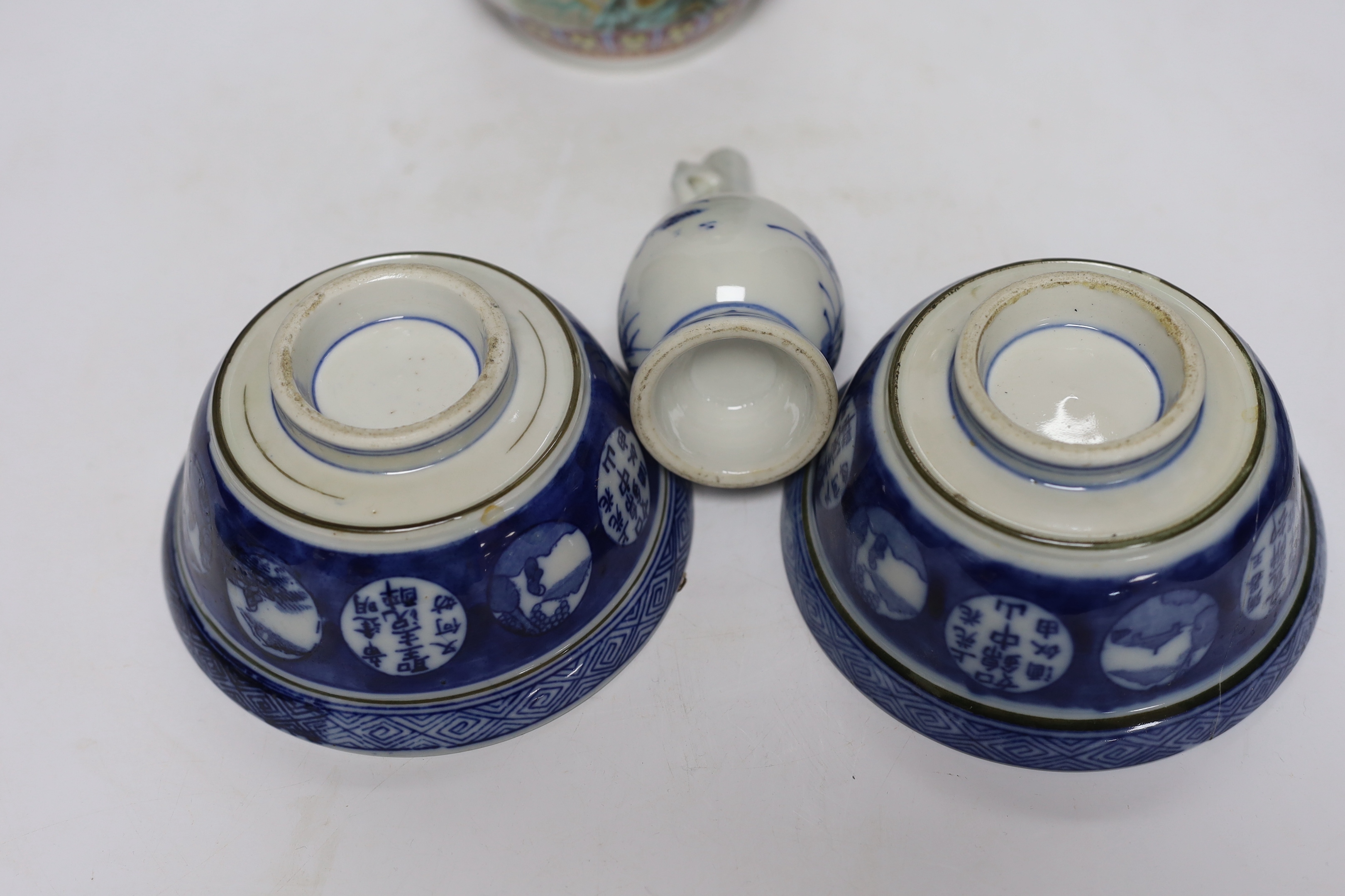A Chinese famille rose vase, two Japanese blue and white rice bowls and covers and a Japanese blue and white vase (4) tallest 24.5cm